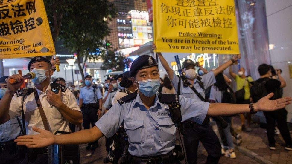 Police officers move on people marking the anniversary of the Tiananmen Square massacre in Hong Kong