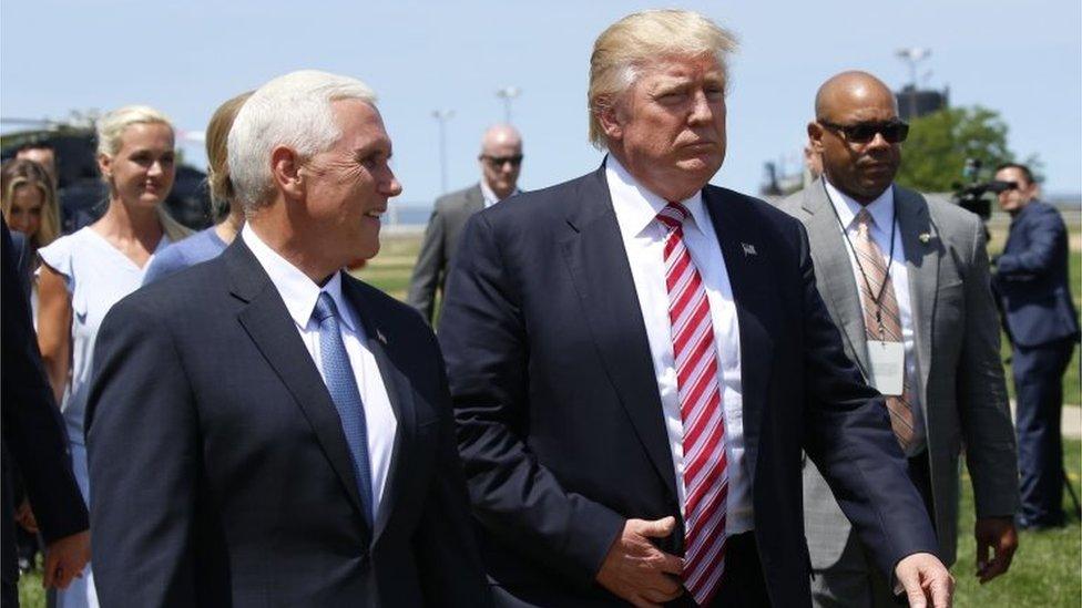 Donald Trump walks with vice-presidential nominee Mike Pence after arriving in Cleveland, Ohio, (20 July 2016)