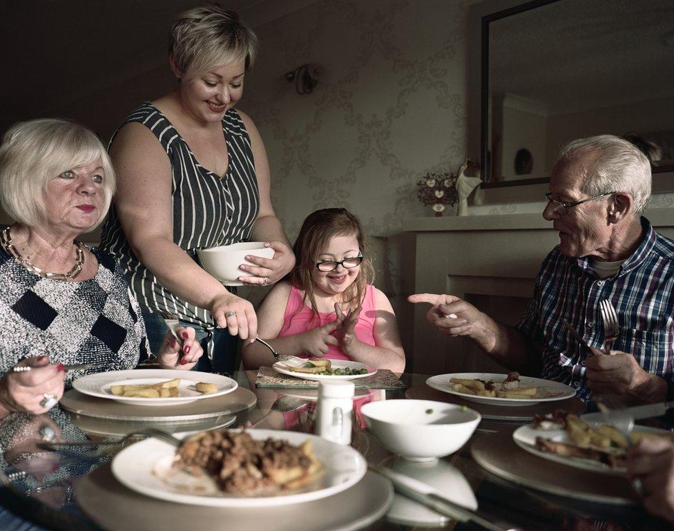 A young girl is served her dinner.