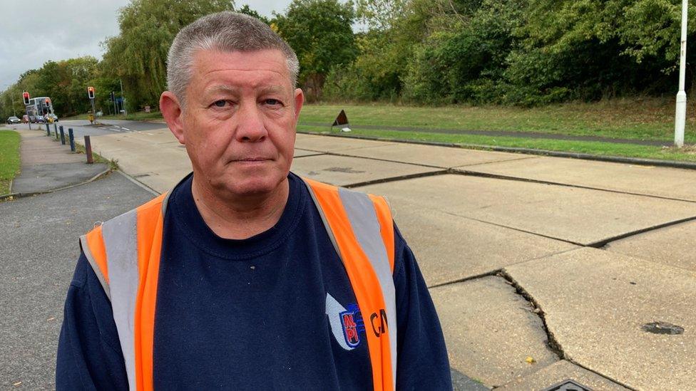 Charlie Mann, warehouse manager at Alpi UK Basildon, standing next to the damaged section of Miles Gray Road