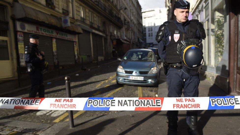 French police stand behind a cordon set up near where the attack happened