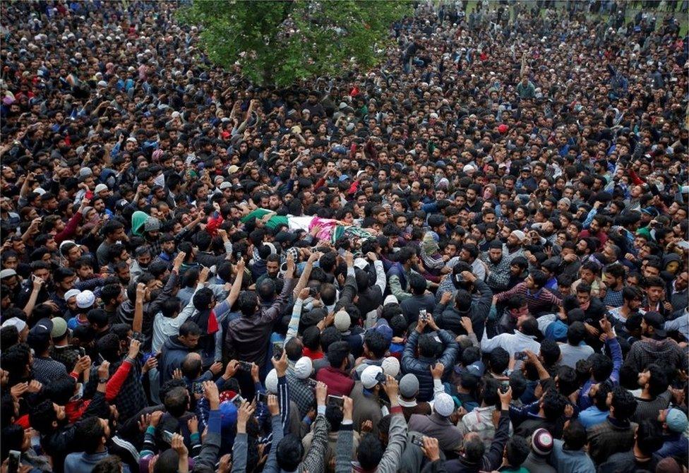 People carry the body of Kashmiri professor Mohammad Rafi Bhat, a suspected militant, after he was killed in a gunbattle with Indian security forces in south Kashmir, during his funeral procession at Chunduna village in Ganderbal district May 6, 2018