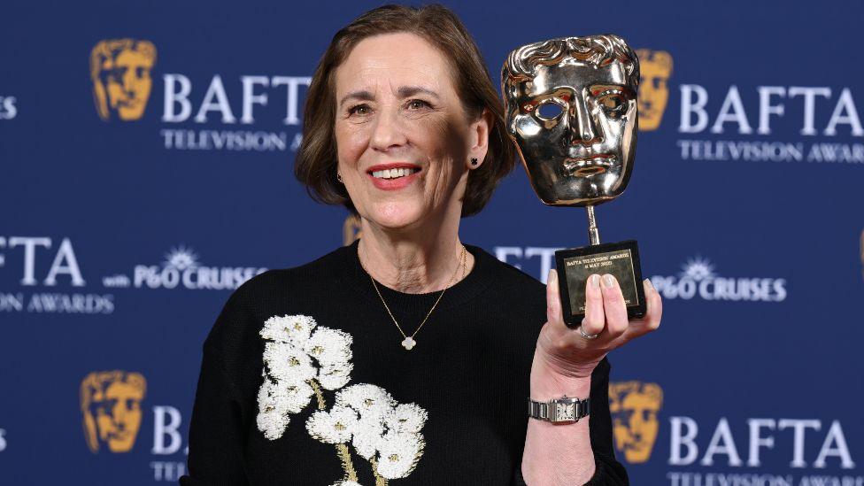 Kirsty Wark poses with the Fellowship Award inside the Winners Room at the 2025 BAFTA Television Awards with P&O Cruises at The Royal Festival Hall on May 11, 2025 in London, England