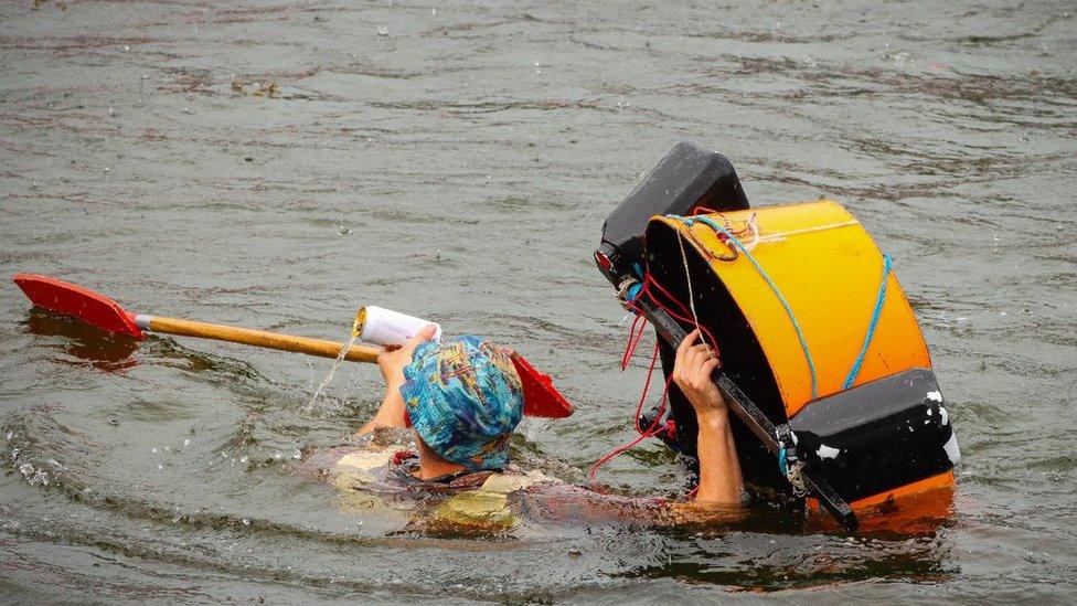 Competitor in the water as a tin bath sinks