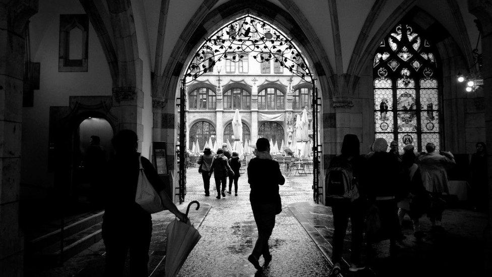 People shelter from the rain