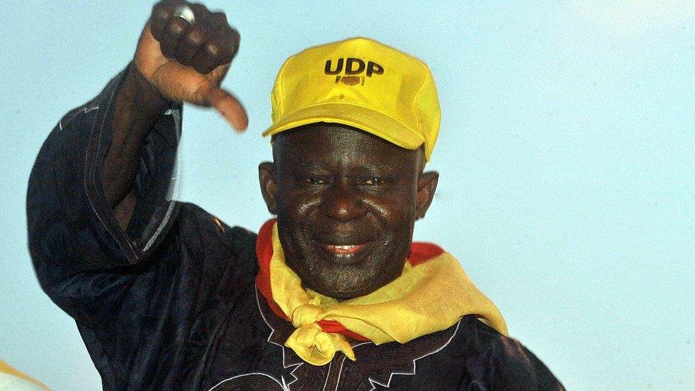 Opposition candidate Ousainou Darboe salutes supporters during a campaign rally on November 22, 2011 in Banjul