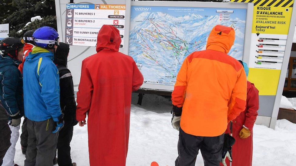 Skiers check for avalanche risks at French Alps resort of Les Menuires - 4 January