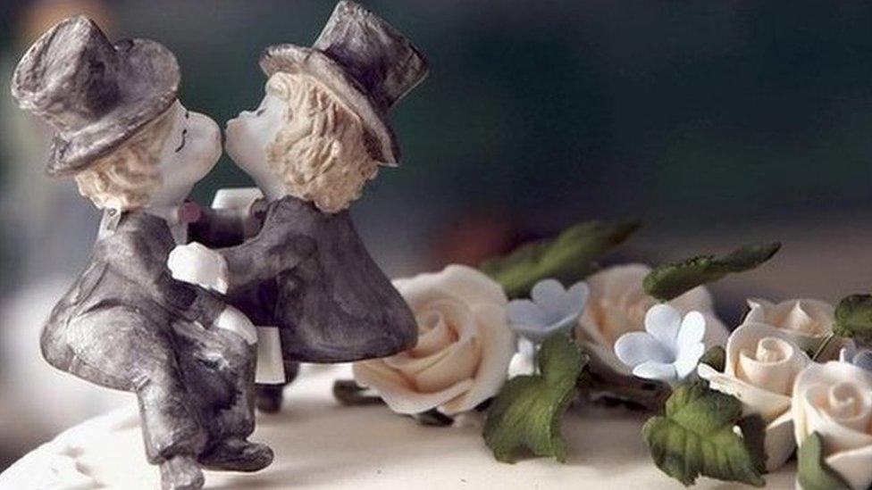 Same-sex statues on wedding cake