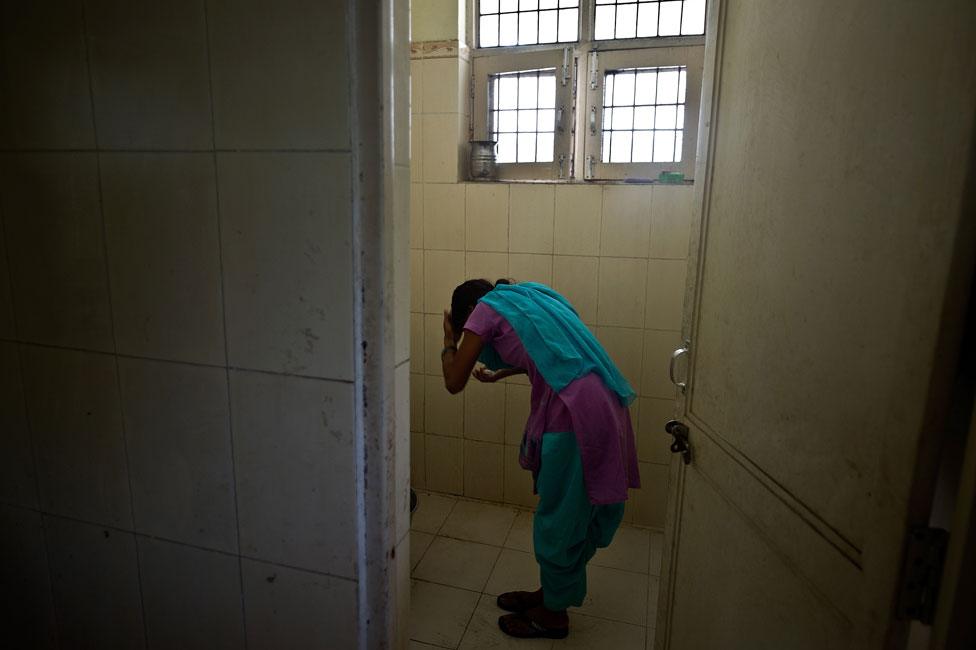 A child washes in a police station after being rescued from traffickers