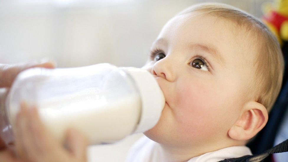 A baby drinking milk from a bottle