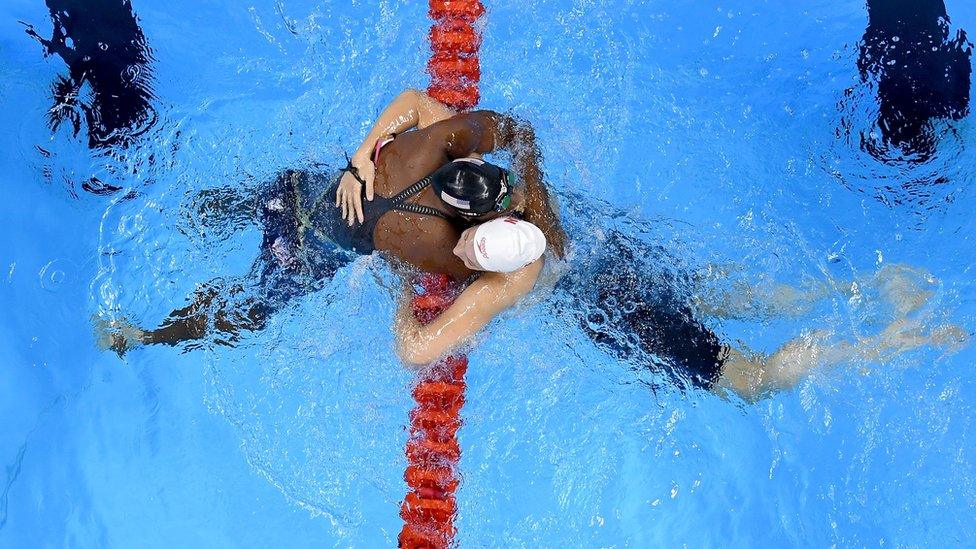 Swimmer Simone Manuel of the United States (L) embraces Penny Oleksiak of Canada after both winning gold