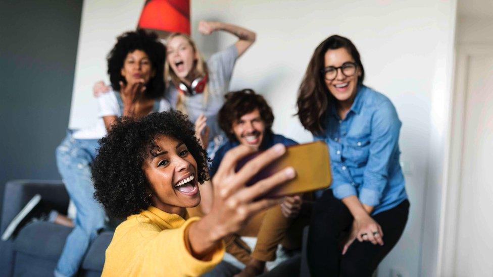 Friends taking a group photograph