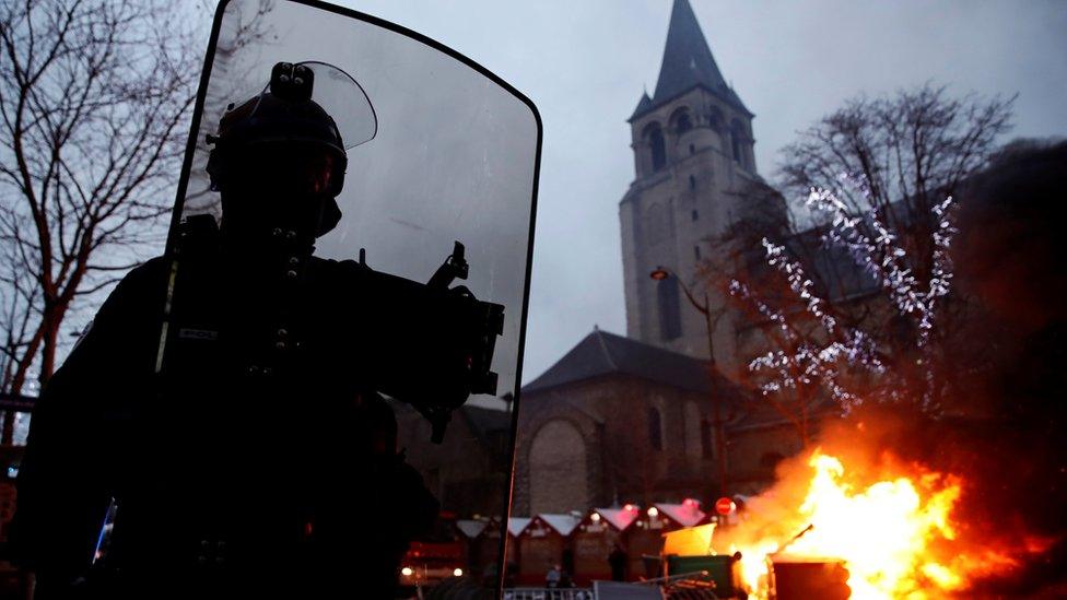 Fire is seen near a Christmas market during a demonstration by the "yellow vests" movement at Boulevard Saint Germain in Paris, France, January 5, 2019