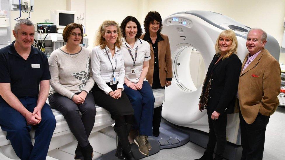 Pictured l-r by our current scanner: Paul Subachus, radiographer; Lisa Airey, radiology manager; Vanina Finocchi, consultant radiologist; Kathleeen McDowall, radiographer; Carole Male, Julie Stokes & David Gawne, Manx Breast Cancer Support Group.