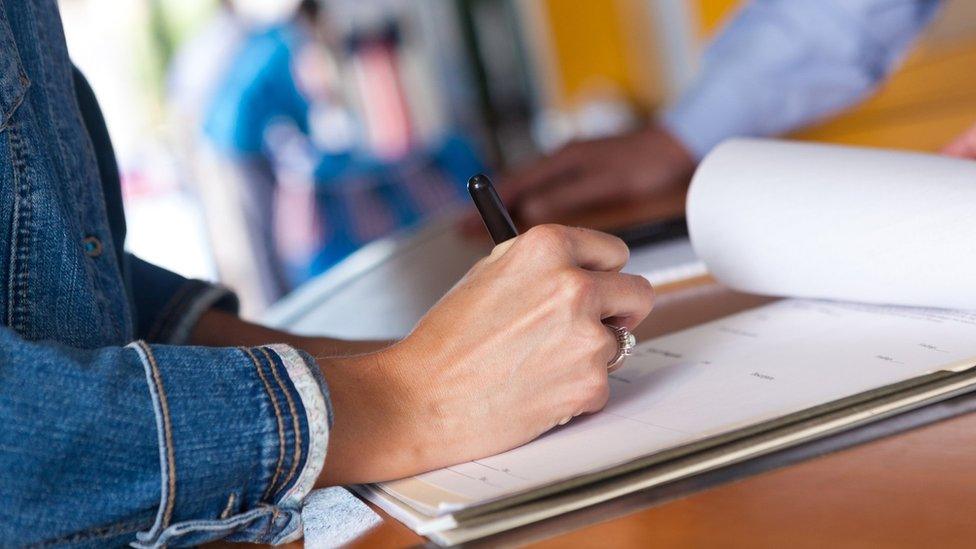 Woman signs document