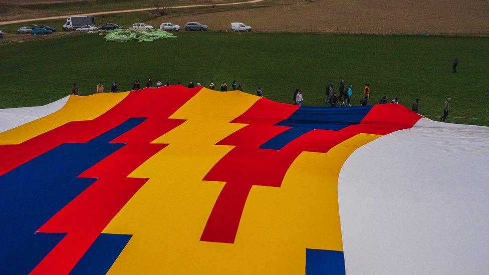 The record breaking T-Shirt with people beside it