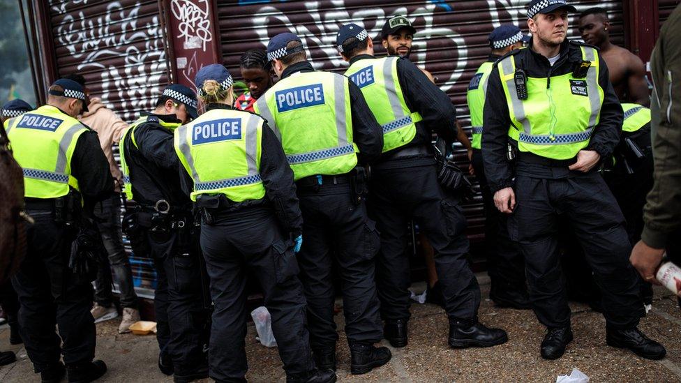 Men in London being stopped and searched by police