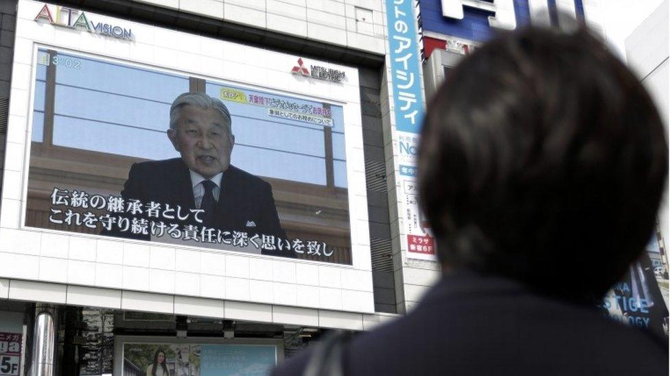 A pedestrian watches a large screen broadcasting Japanese Emperor Akihito"s video message on his thoughts, in Tokyo, Japan, 08 August 2016.