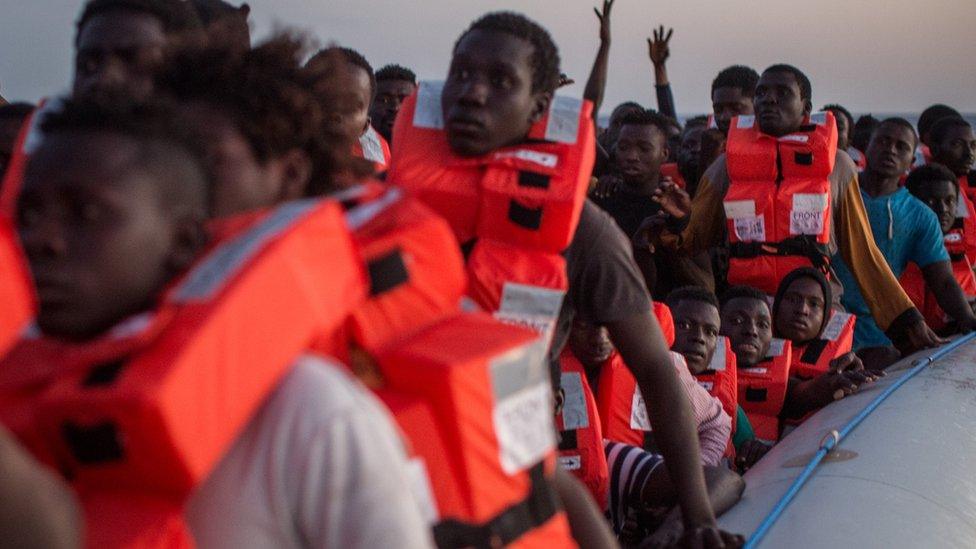 Refugees and migrants wait in a small rubber boat to be rescued off Lampedusa on 10 June, 2017