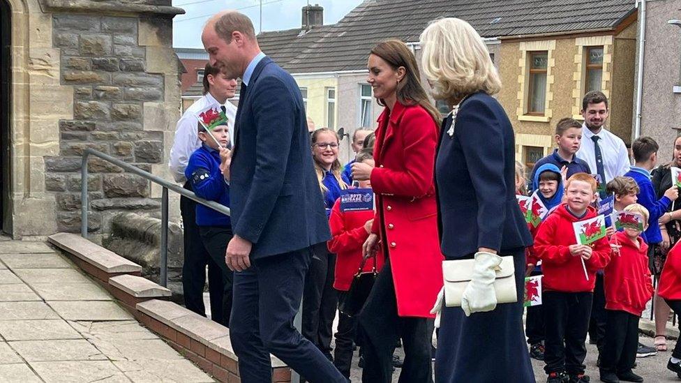 The couple were met by crowds of flag waving children