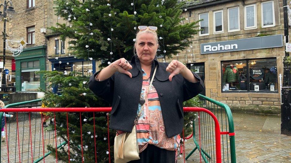 Joann Rotherer in front of Christmas tree