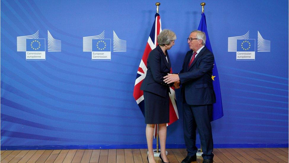 European Commission President Jean-Claude Juncker shakes hands with British Prime Minister Theresa May