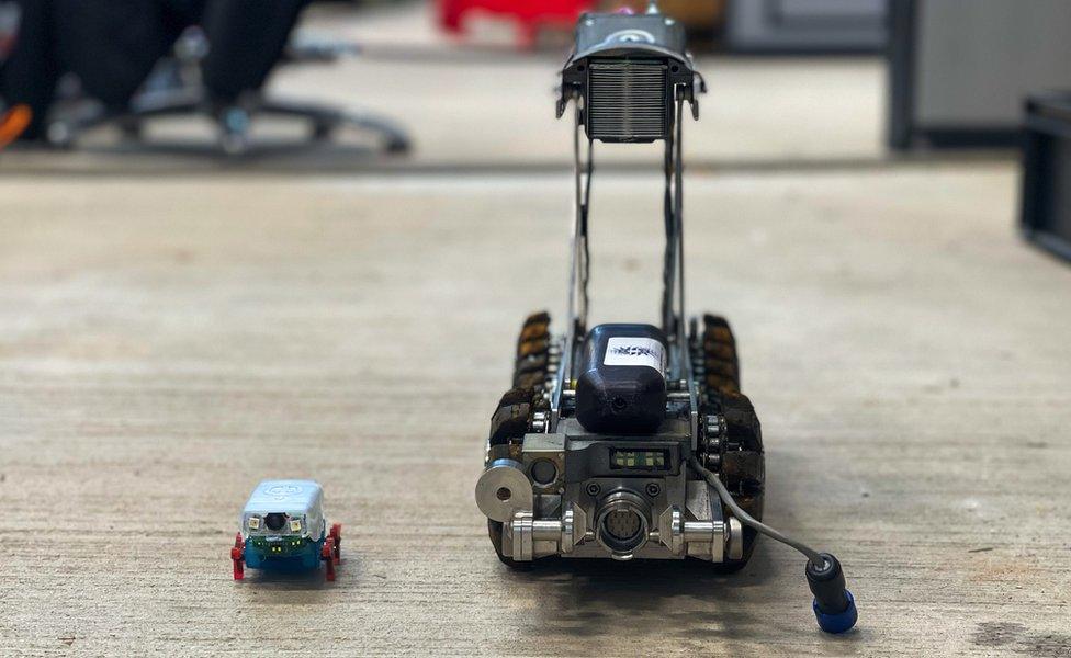 A pipebot (left) next to a larger, current inspection robot