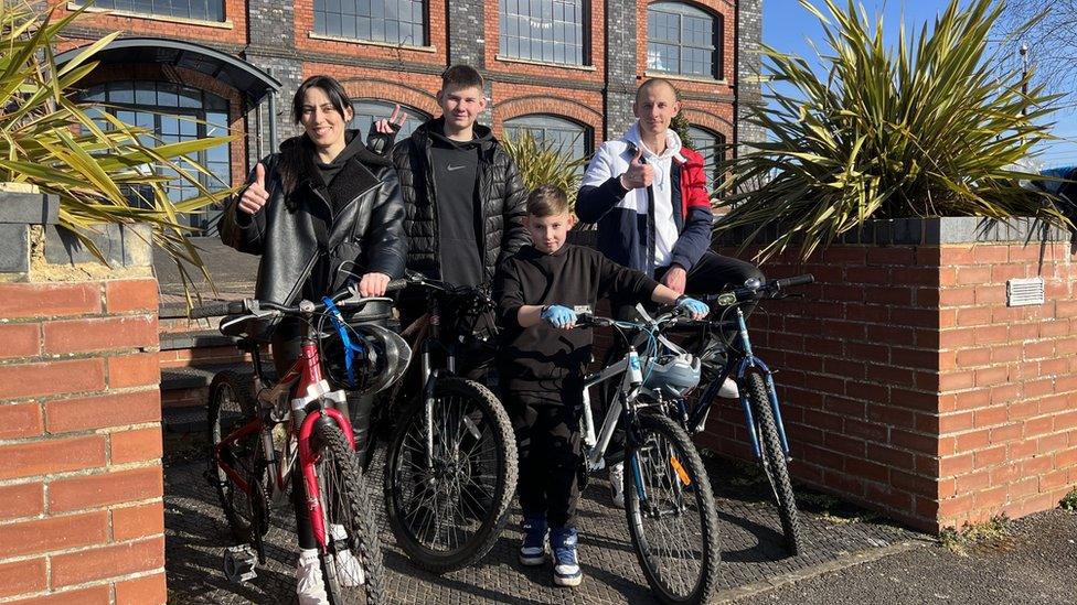 Four young people with bikes