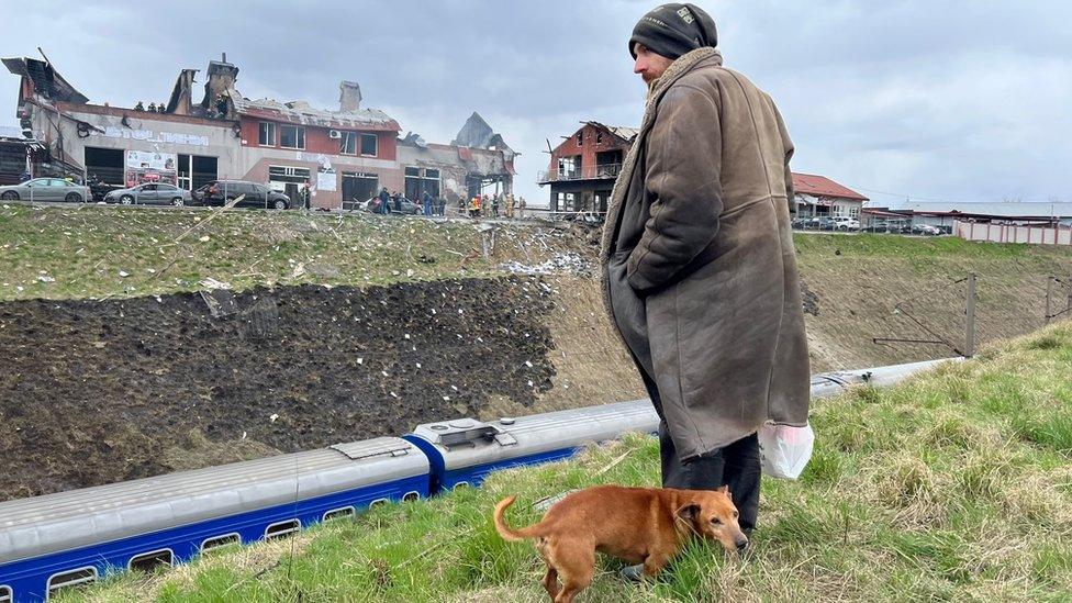 A man looks at the site of a Russian attack in Lviv