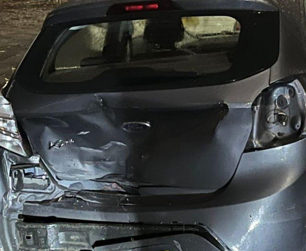 A car with significant rear damage