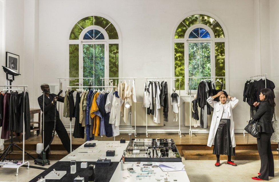 Clothes are seen on the rails of the Marche Noir shop in Paris.