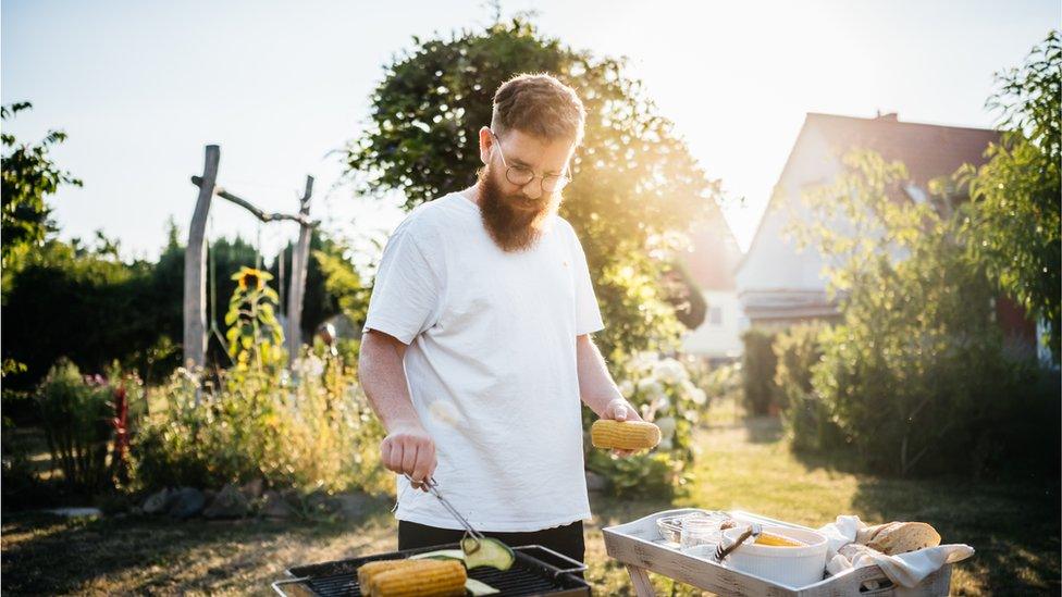 A man cooking on a barbecue