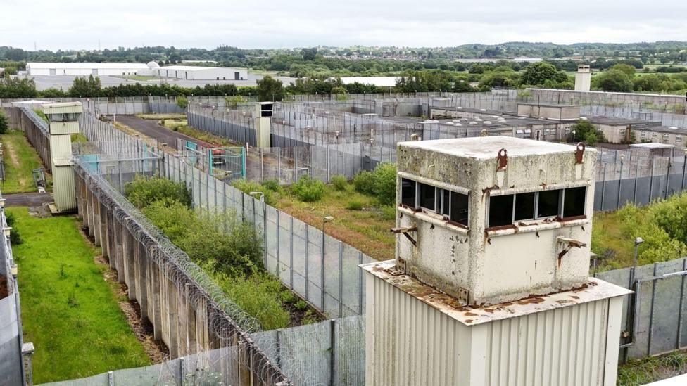 The disused buildings of the Maze prison near lisburn, surrounded in high fences and barbed wire