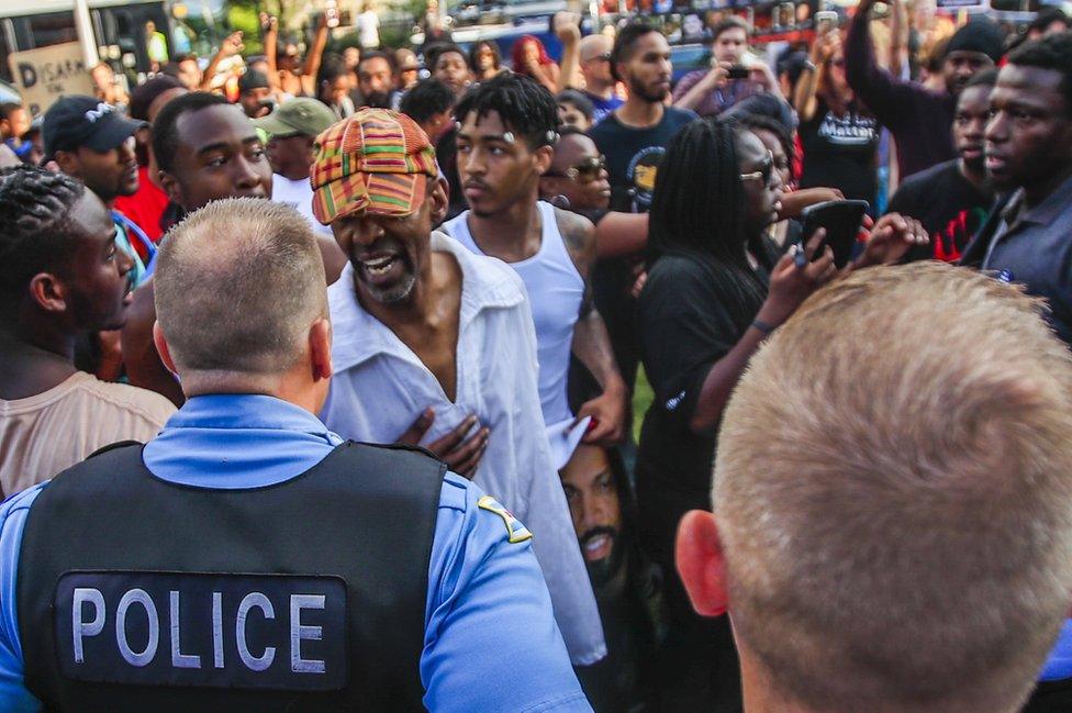 Activists gather to march, shout, pray and protest against the alleged shooting of Harith Augustus by a Chicago Police officer during a confrontation in Chicago, Illinois, USA, 15 July 2018.