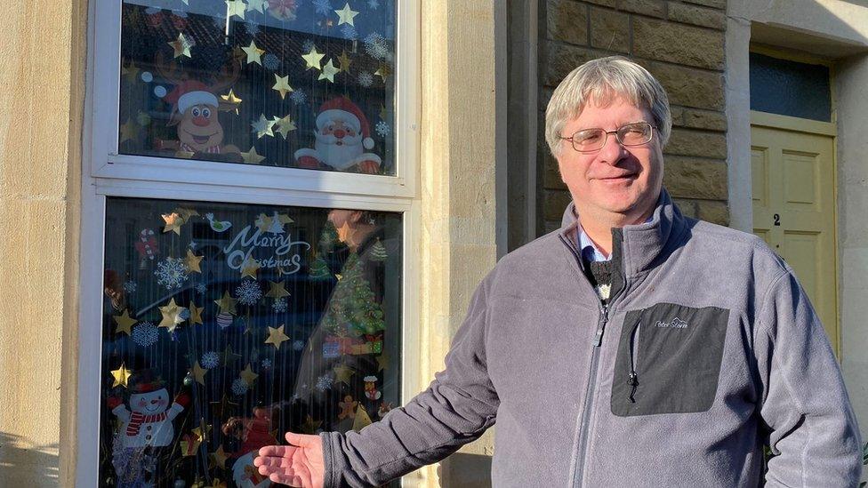 Mike in front of his house