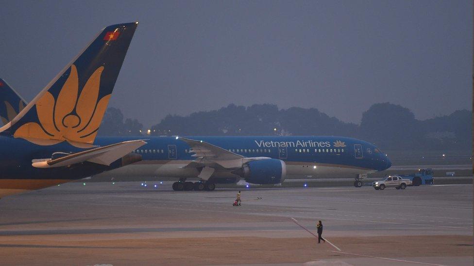 Vietnam Airlines plane carrying the remains of some of the 39 people found dead in a truck in Britain last month