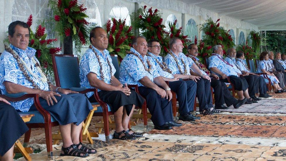 Leaders in matching shirts all sit in a line