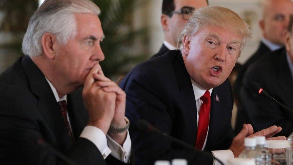 U.S. President Donald Trump (R) speaks next to Secretary of State Rex Tillerson during a bilateral meeting with China"s President Xi Jinping