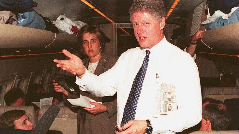 US President Bill Clinton talks with reporters as he returns to Washington aboard Air Force One, late 05 April, following appearances in North Carolina