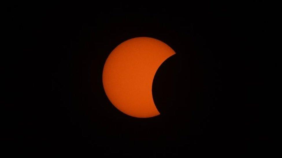 The Moon starts to move in front of the Sun in a rare "ring of fire" solar eclipse, as seen from Wan Twin in central Myanmar (Burma). Photo: 26 December 2019