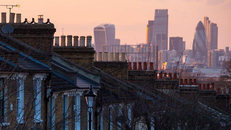 File image showing a row of rooftops with London's city skyscrapers in the background