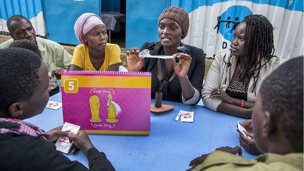 Members of Youth to Youth program supported by DSW (Deutsche Stiftung Weltbevoelkerung), an international development and advocacy organization with focus on achieving universal access to sexual and reproductive health and rights, during a meeting about family planning and sexual reproductive health where they demonstrate condom usage and options for contraceptives. June 10, 2014 in Nairobi, Kenya.