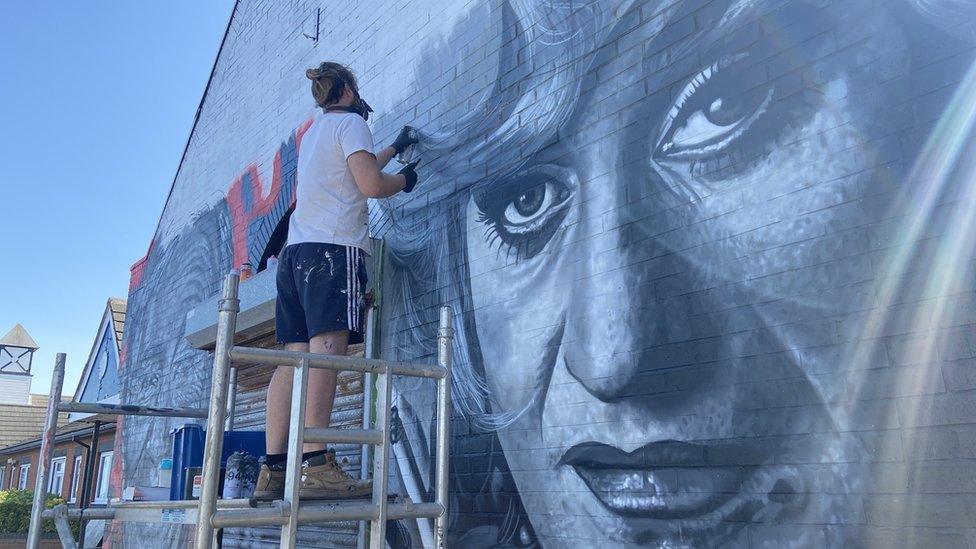 Artist Brezaux working on his mural tribute to Paul O'Grady