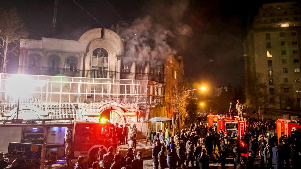 Smoke rises as Iranian protesters, upset over the execution of Shia cleric Nimr al-Nimr in Saudi Arabia, set fire to the Saudi embassy in Tehran (3 January 2016)