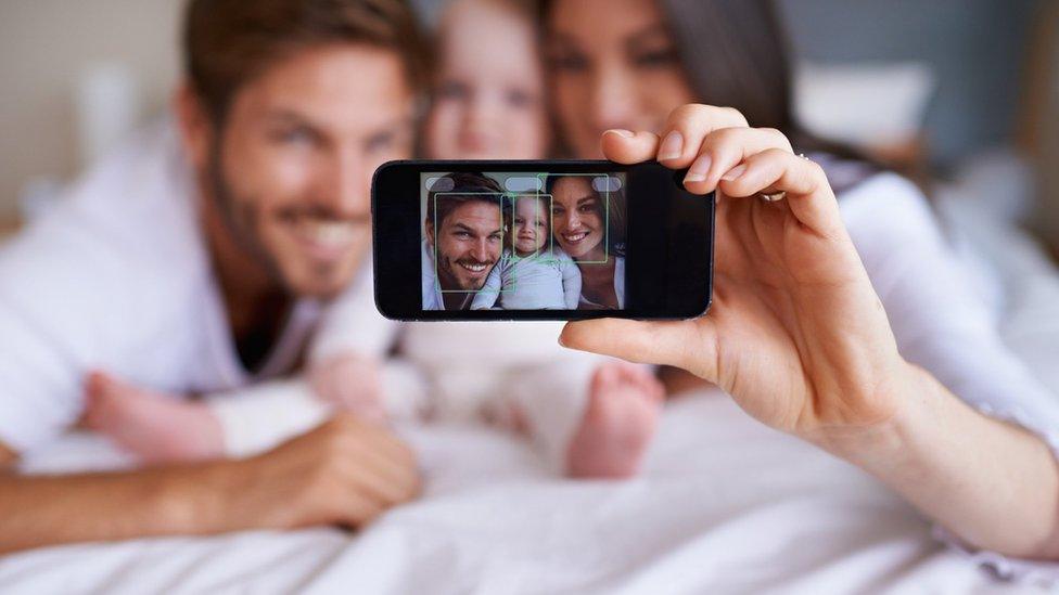 Family taking selfie on phone