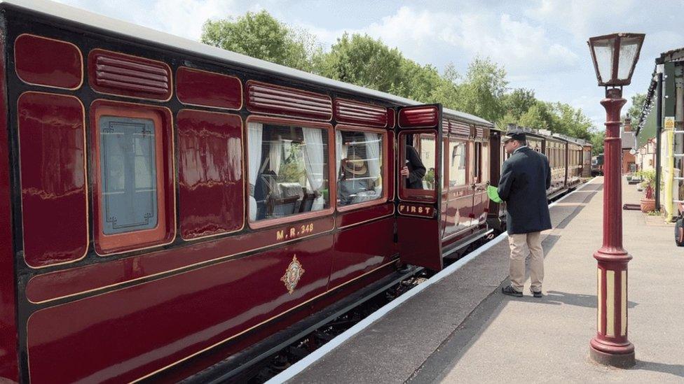 Midland Railway company coach standing at platform