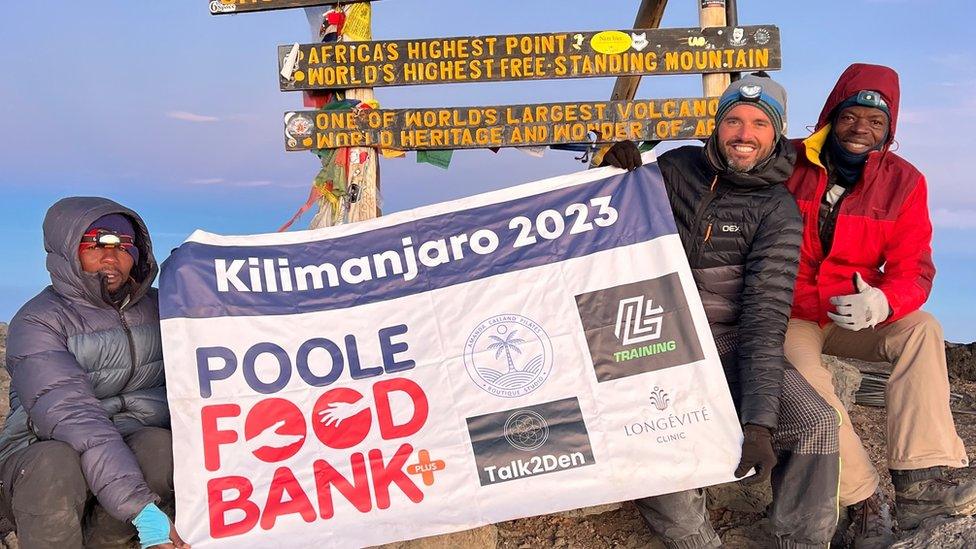 Joshua Mitchell at the top of Mt Kilimanjaro