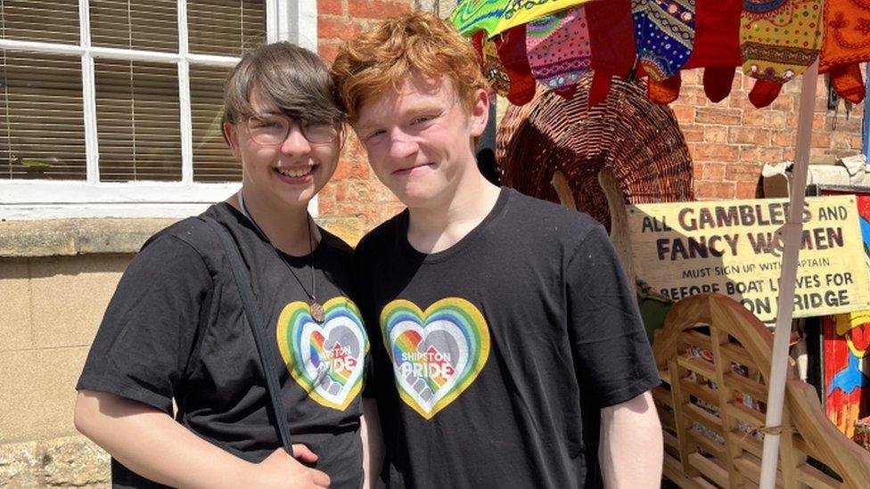 Josh and Chelsey smiling at a stall