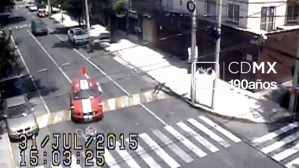 This still image from footage of a surveillance camera shows the car of one of the victims being driven away