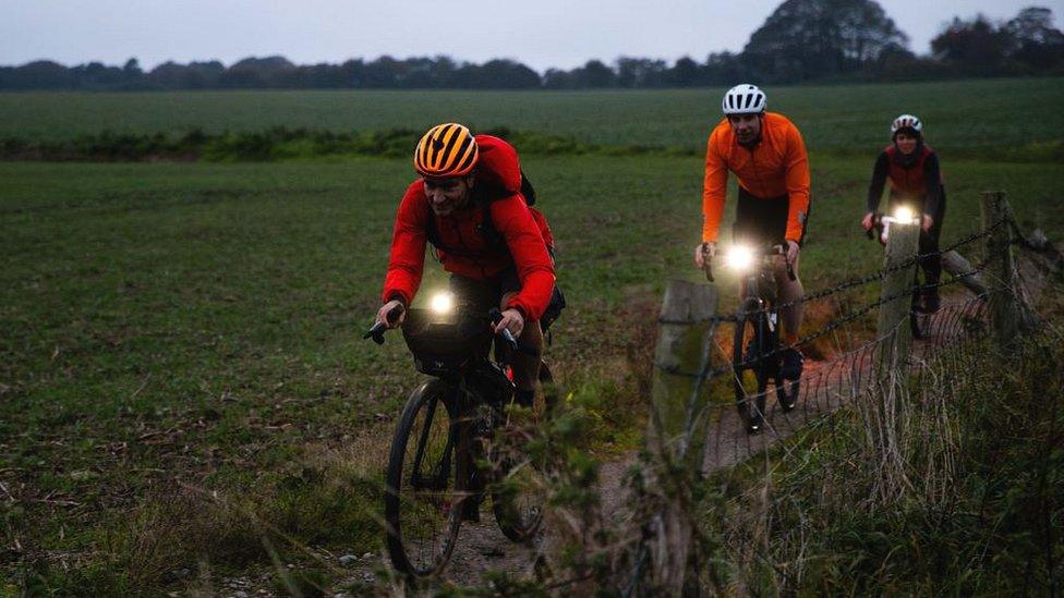 Three cyclists